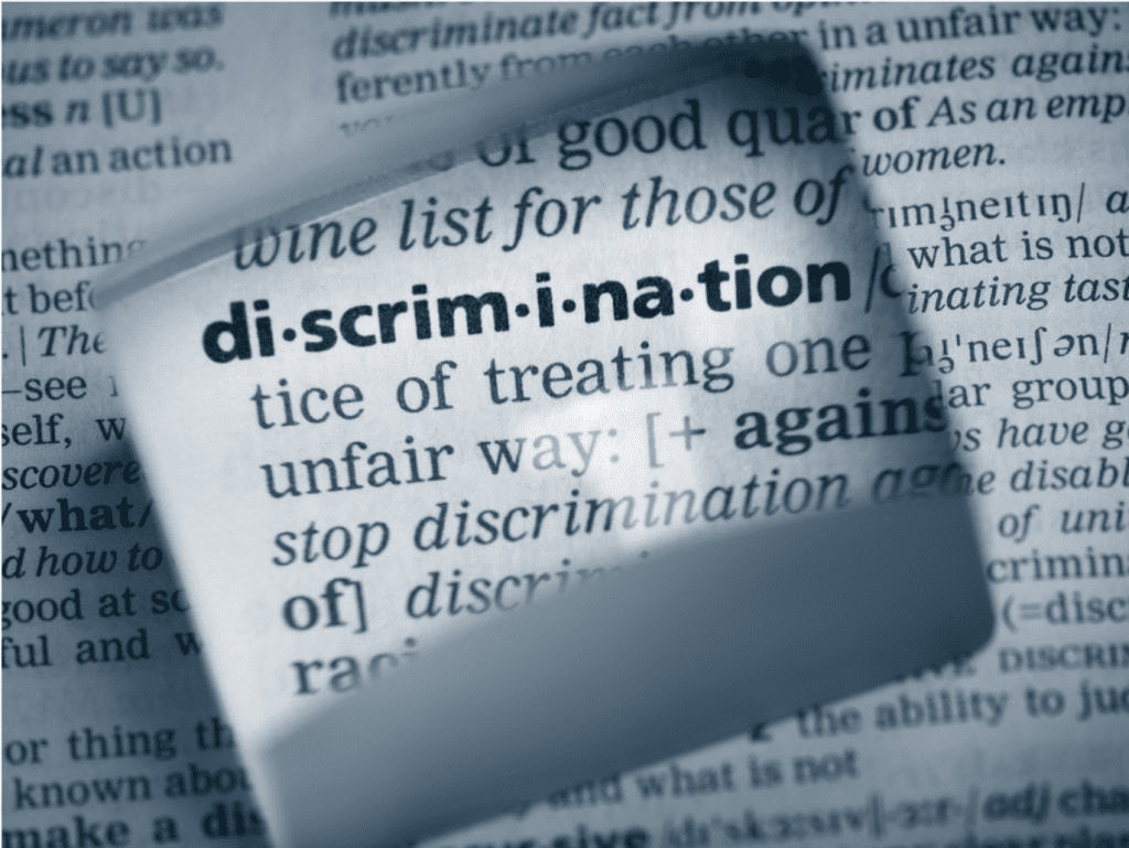 Close-up of dictionary definition of “discrimination” to signify discussion of insurance redlining.